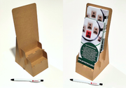 Cardboard display stand with printed materials and a pen on a white background